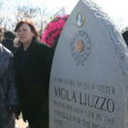 Evelyn G. Lowery and Mary Liuzzo Lilleboe stand next to the SCLC/W.O.M.E.N. memorial monument for Viola Liuzzo, Lilleboe's mother.
