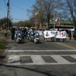 Demonstrators march with Southern Christian Leadership Conference banners in Selma, Alabama as part of the annual Bridge Crossing Jubilee celebration.