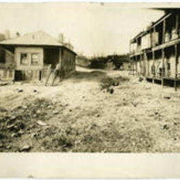 Visual of dilapidated slum houses and yard, circa 1895.