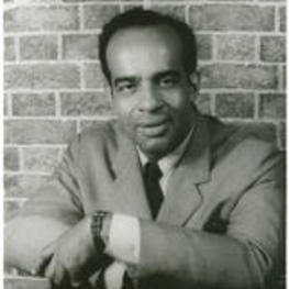 Portrait of Hubert Dilworth in front of a brick patterned background. Written on verso: Hubert Dilworth, Leontyne Price's Secretary; Photograph by Carl Van Vechten; 146 Central Park West; Cannot be reproduced without permission; August 28, 1963.
