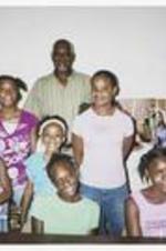A group of girls with Don Green at Vacation Bible School. Written on verso: Vacation Bible School - 2007. Front row-sitting (left to right) Brianna Jones and unknown girl. 2nd row: Alexis McKnight, [Amiyah] McCoy and Destiny Summers. 3rd row: Don Green.