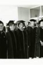 Written on verso: Spelman Commencement 1987. From L: Donald M. Stewart, former Spelman President and honorary degree recipient; Marian Wright Edelman, Chair, Spelman Board of Trustees; Lena Horne, Commencement Speaker and honorary degree recipient; Leontyne Price, honorary degree recipient; Barbara L. Carter, Acting President; Johnnetta B. Cole, newly appointed President; Jacob Lawrence, honorary degree recipient. Photo courtesy of Spelman College.
