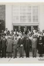 James P. Brawley, Anne E. Hall and others pose for a group portrait on the steps of a building.
