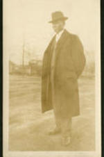 An unidentified man in trench coat.
