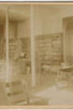 Interior of the Graves Library in Stone Hall with students. Illegible names written small on verso of image.