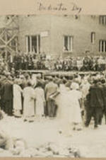 A large group gathers at a building dedication and listens to a speaker. Written on recto: Dedication Day - May, 1926