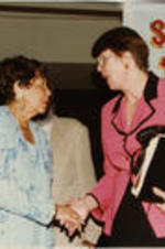 Evelyn G. Lowery is shown shaking hands with U.S. Attorney General Janet Reno at the 39th Annual Southern Christian Leadership Conference Convention.