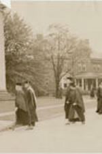 A line of faculty, students, and staff from the Atlanta University Center form a procession before the dedication of the Trevor Arnett Library. Written on verso: Speakers and guests of honor entering Sisters Chapel on Spelman campus on library dedication day. The exercises were held in this chapel instead of on the campus adjoining the library on account of a drenching rain that fell all Saturday morning
