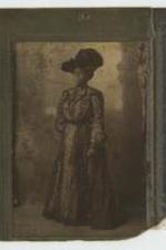 Portrait of a woman in hat and gown.