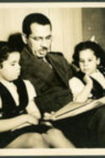 Brailsford R. Brazeal read to his daughters, Aurelia Erskine and Ernestine Walton Brazeal.