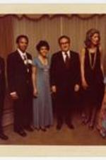 Group portrait in the home of Dr. Albert E. Manley. Written on recto: April 1974. In the home of Dr. and Mrs. Manley; from l to r - Dr. Manley, Congressman and Mrs. Andrew Young, Dr. and Mrs. Henry Kissenger, and Mrs. Manley.
