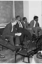 C. Eric Lincoln sits on a panel at the London School of Economics. Written on verso: Second from left- Wiley Branton, Little Rock Arkansas "9" attorney, civil rights lawyer.