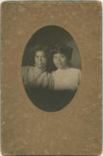 Portrait of two women, one in a light top (possibly Elizabeth McDuffie) and another in a darker top.