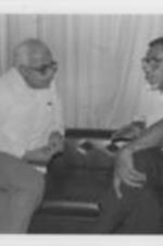 Southern Christian Leadership Conference President Joseph E. Lowery meets with Caesar Jerez, the rector of Central American University, during his visit to Nicaragua. For more information, see pages 13-17 in the January-February 1987 SCLC Magazine issue: http://hdl.handle.net/20.500.12322/auc.199:07032. Written on verso: From the General Assembly the SCLCers attended an informal luncheon where they talked with missionaries of the Witness for Peace group; Catholic nuns and representatives of the academic community. Here Lowery chats with Caesar Jerez, rector of Central American University.
