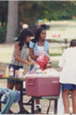 Two young girls stand at a picnic table during a SCLC/W.O.M.E.N. Bridging the Gap: Girls to Women Mentoring Program event.