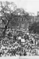 Southern Christian Leadership Conference President Joseph E. Lowery is shown speaking to a crowd of demonstrators in Chester, South Carolina. Written on verso: Chester, South Carolina, 2,000 protest killing of 18 year old Mickey McClinton by unknown persons for allegedly dating a white woman.
