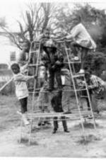 Unidentified Children playing outside on a jungle gym.