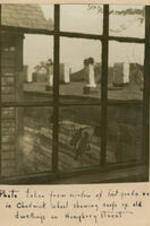 View of housetops outside a window. Written on recto: Photo taken from window of first grade room in Chadwick School showing roofs of old dwellings on Humphrey Street.