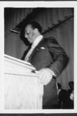 A man speaks from the pulpit.
