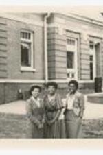 Outdoor group portrait of three women. Written on verso: "Homecoming Court 1984; L to R Michelle Patmon, Phyliss Hall, Rodesia Ashe".