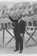 Ralph D. Abernathy is shown pointing upward while standing in the Colosseum in Rome, Italy.