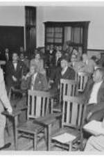 A group of men meet in a classroom. Written on verso: Leaders of the Central Jurisdiction meet at Gammon, 1953.