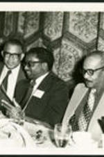 Dr. Vivian Wilson Henderson speaking with an unidentified man at an unidentified event.