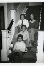Portrait of the Stewart family at home sitting on stairs.