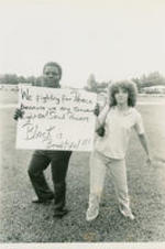 An unidentified man and woman are shown holding a protest sign that reads "We fighting for peace because we are somebody. Light (Fight?) on! Soul Powers. Black is Beautiful!!!"