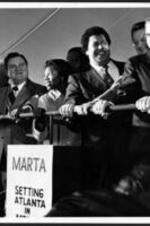 View of Maynard Jackson at the MARTA groundbreaking ceremony. A sign reads "MARTA, setting Atlanta in motion."