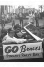 Felipe Alou and others ride in a car at a Braves Pennant Rally parade. Written on accompanying document: Alou, Felipe.