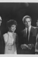 Producer Ely Landau and film stars Ruby Dee and Paul Newman are shown conversing with director Sidney Lumet. Attached caption reads: STARS WORK FOR KING TRIBUTE -- Photo left to right: Producer Ely Landau, and film stars Ruby Dee and Paul Newman confer with director Sidney Lumet in New York City just prior to filming special dramatic reading sequences for the two-and-a-half-hour motion picture film: "KING: A Filmed Record...Montgomery to Memphis", scheduled to be shown on Tuesday evening, March 24th at 8:00 P.M. on a one-time only simultaneous showing in more than one thousand theaters across the country. Tickets are $5 tax-deductible. Total proceeds will go into the Martin Luther King Jr. Special Fund which will seek through its program to support Dr. King's principles and ideals of using non-violent methods in the war on poverty and illiteracy and the struggle for civil and human rights for all peoples.