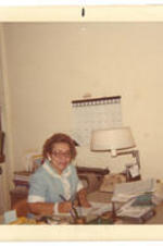 Virginia Lacy Jones works in her office. Written on Verso: Virginia L. Jones at work [ALISLIS?].