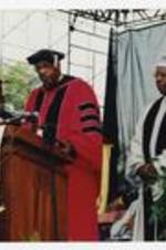 Thomas W. Cole, Jr. stands with Hank Aaron at the podium at commencement.