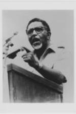 Joseph E. Lowery speaking at a podium and pointing with his left hand.