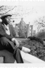 C. Eric Lincoln sits and smokes a pipe at the University of Chicago.