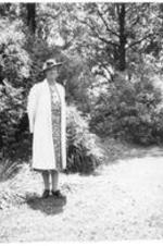 Louise Allyn stands in a yard in front of a birdbath. Written on verso: Mrs. Louise H. Allyn. Taken at Trinity School, Athens, Alabama, about 1940.