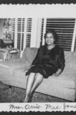 Mrs. Orrie Mae Jones sitting on sofa in a living room. Written on recto: Mrs. Orrie Mae Jones