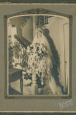 Portrait of unidentified bride standing on a staircase.