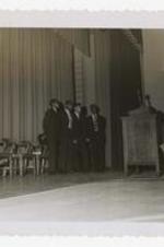 Four men on stage at a Kappa Alpha Psi event.