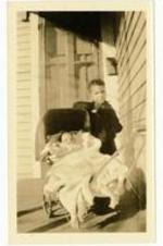 Gladstone "Mickey" Chandler, Jr. &amp; Beth I. Chandler as children on porch. Written on verso: Beth at 3 months about to go for an outing with brother. Mickey claimed her from birth as belonging to him.