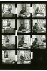Proof sheet Hoyt Fuller and an unidentified woman working at a typewriter.
