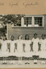 A group of girls stand outside the Chadwick school. Written on recto: Eighth grade graduates.