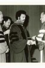 President Hugh Gloster presenting Honorary degree to Rev. Jesse Jackson on stage.