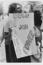 An unidentified woman holds a sign that reads "Join SCLC Woman Power" at a march prompted by the killing of the Russaw brothers by police officers in Eufaula, Alabama.