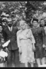 Lemoine DeLeaver Pierce's maternal grandparents Luther and Alice White, standing outside together with other family members.