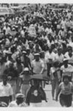 Demonstrators are shown marching in Eufaula, Alabama to protest policy brutality in response to the killings of Hamp Russaw and Anthony Russaw by police officers.