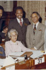 Grace Townes Hamilton at her desk with Lottie Watkins, Clint Deveaux, and others at the Georgia House of Representatives.