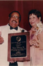 Evelyn G. Lowery poses for a photo with Hosea Williams at the 20th Annual SCLC/W.O.M.E.N. Drum Major for Justice Awards dinner. Williams was the recipient of the Drum Major for Justice Pioneer Award. Written on verso: Drum Major for Justice Awards Dinner, June 4, 1999