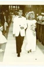 Unidentified man and woman walking down the aisle at the wedding of Beth A. Chandler and Theodore John Warren.